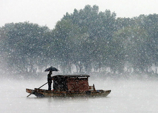 12月5日，杭州降下2015年入冬第一場雪。沒有一點點防備，杭州的初雪就洋洋灑灑地飄落了，雪越來越大，氣溫也驟降，西湖的水面上飄起層層白霧，與雪花攪在一起，如夢似幻。林云龍 視覺中國